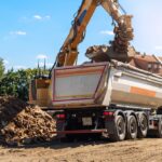 Heavy,Excavatore,Machine,Uploading,Waste,And,Debris,Rubble,Into,Dump