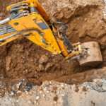 Bucket,Of,Modern,Yellow,Excavator,Digs,Deep,Pit,To,Change