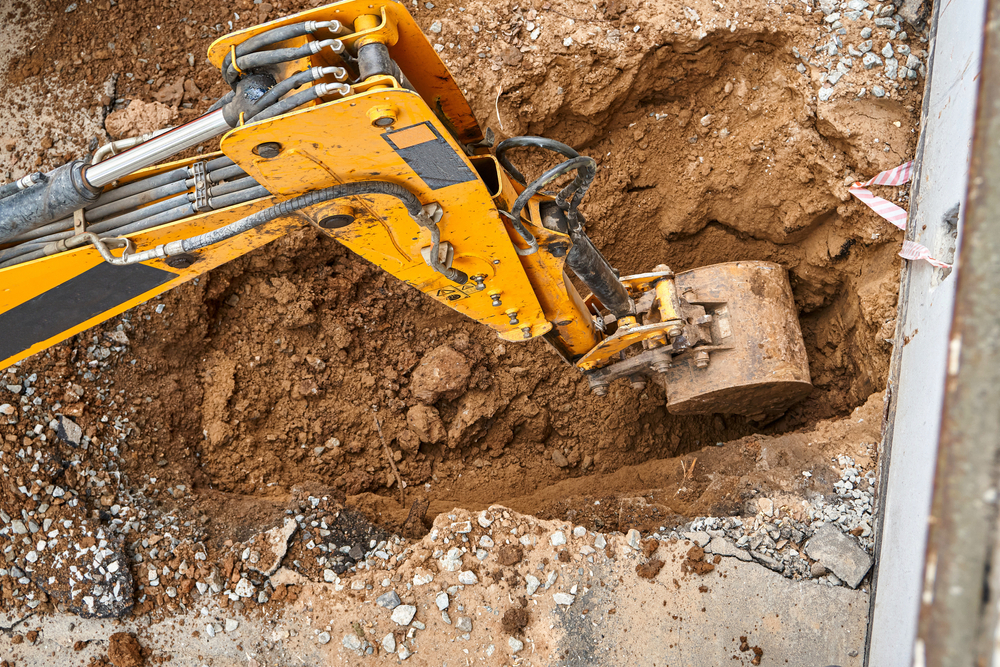 Bucket,Of,Modern,Yellow,Excavator,Digs,Deep,Pit,To,Change