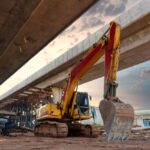 Excavator,Heavy,Machine,At,Structure,Road,Construction,Of,Expressway,Under