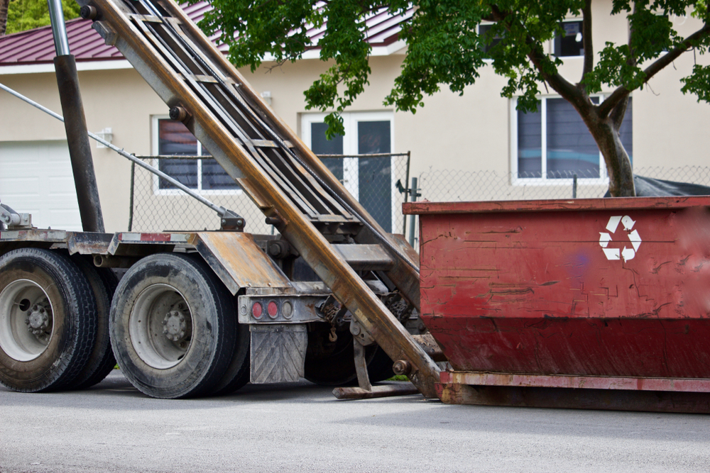 Empty,Construction,Dumpster,Being,Unloaded,From,Truck,At,Residential,Construction